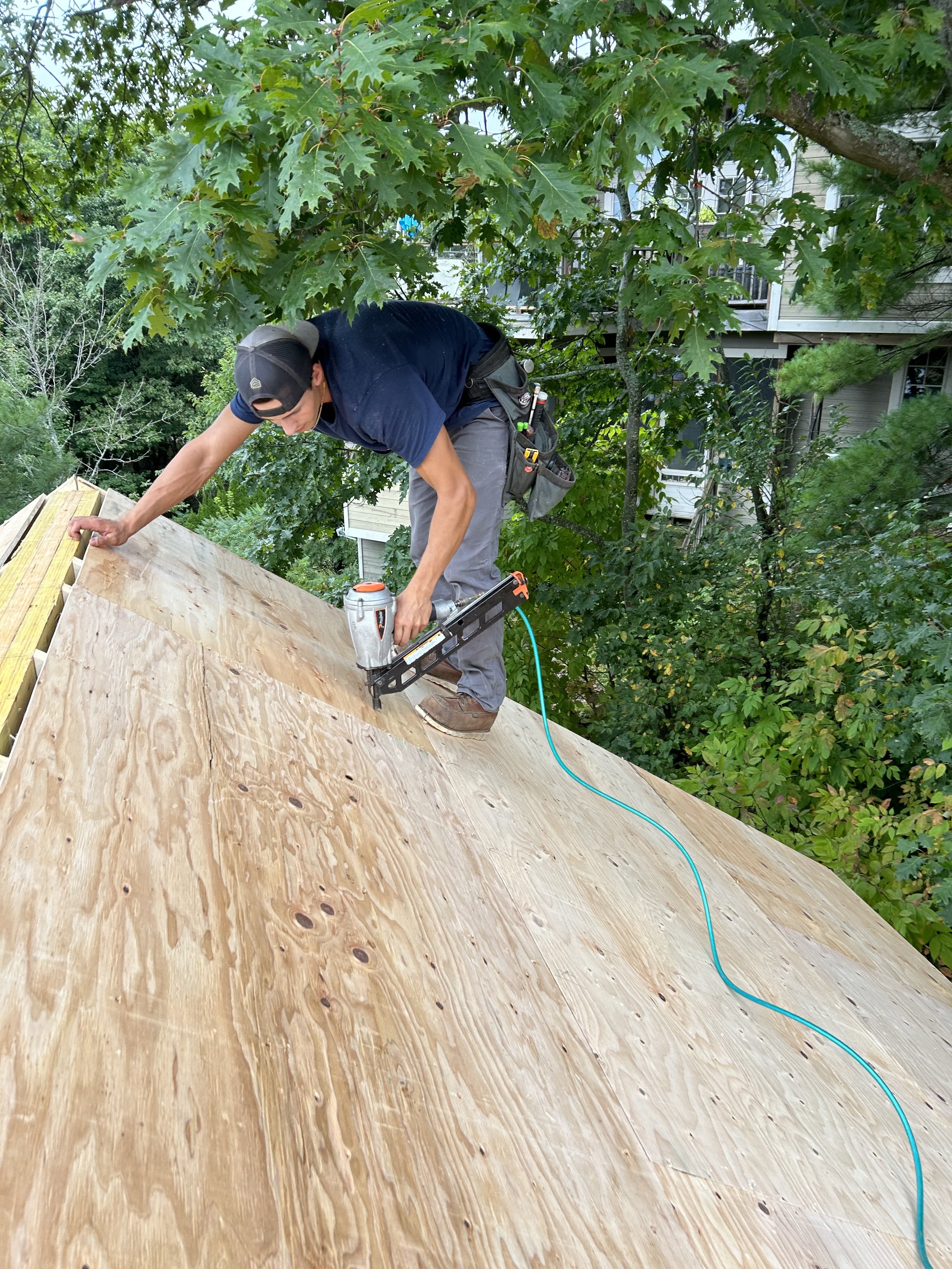 Eric Pinard working on a roof with a framing nailer